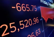 Asian shares mostly lower as investors watch trade talks