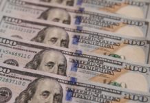 Dollar steady, Aussie reverses losses after RBA holds rates