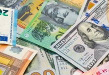 Dollar drops to one-month lows on questions over U.S. growth