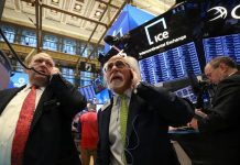 Wall Street hit again by growth worries; blue-chip earnings prop up Dow