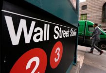 Wall Street rises at open, lifted by upbeat earnings