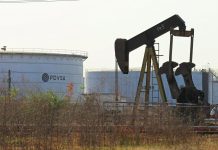 Oil prices slip as US stocks surge, but global market tightens