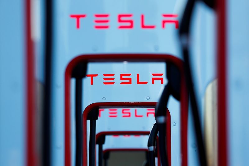 Musk defies skeptics, meets Tesla delivery goal; shares hit record