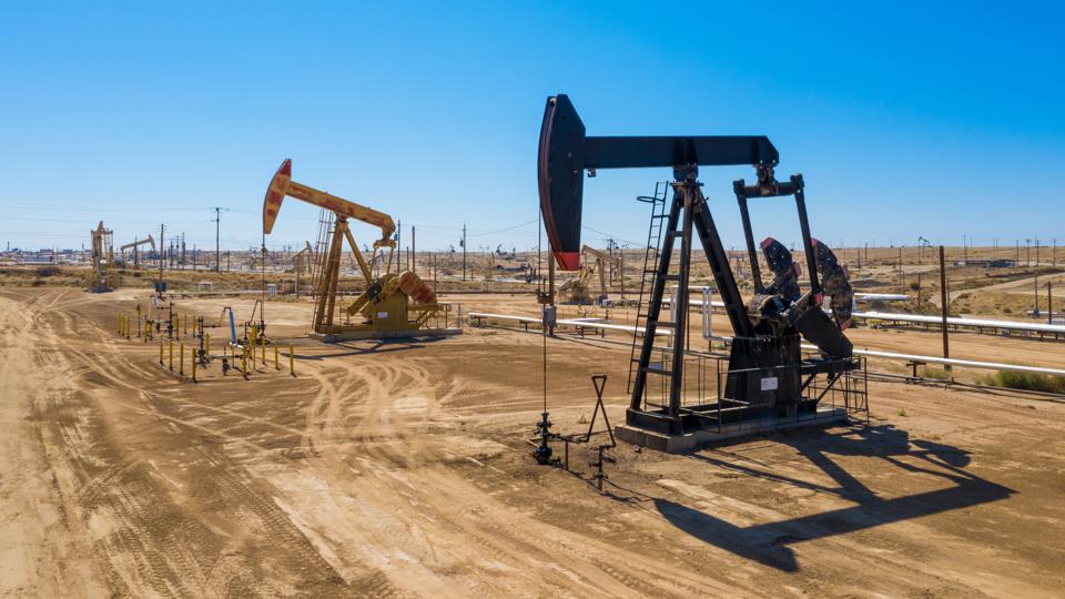 Oil prices hit near 12-month highs as producers restrain output