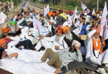 Indian farmers squat on railway tracks to mark four months of protests