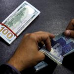 FILE PHOTO: A currency trader counts Pakistani Rupee notes as he prepares an exchange of U.S dollars in Islamabad