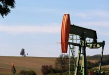 Oil drops as investors weigh a supply surplus outlook and US-China trade tensions