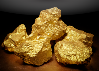 Gold steadies on stronger dollar as investors trim rate-cut bets